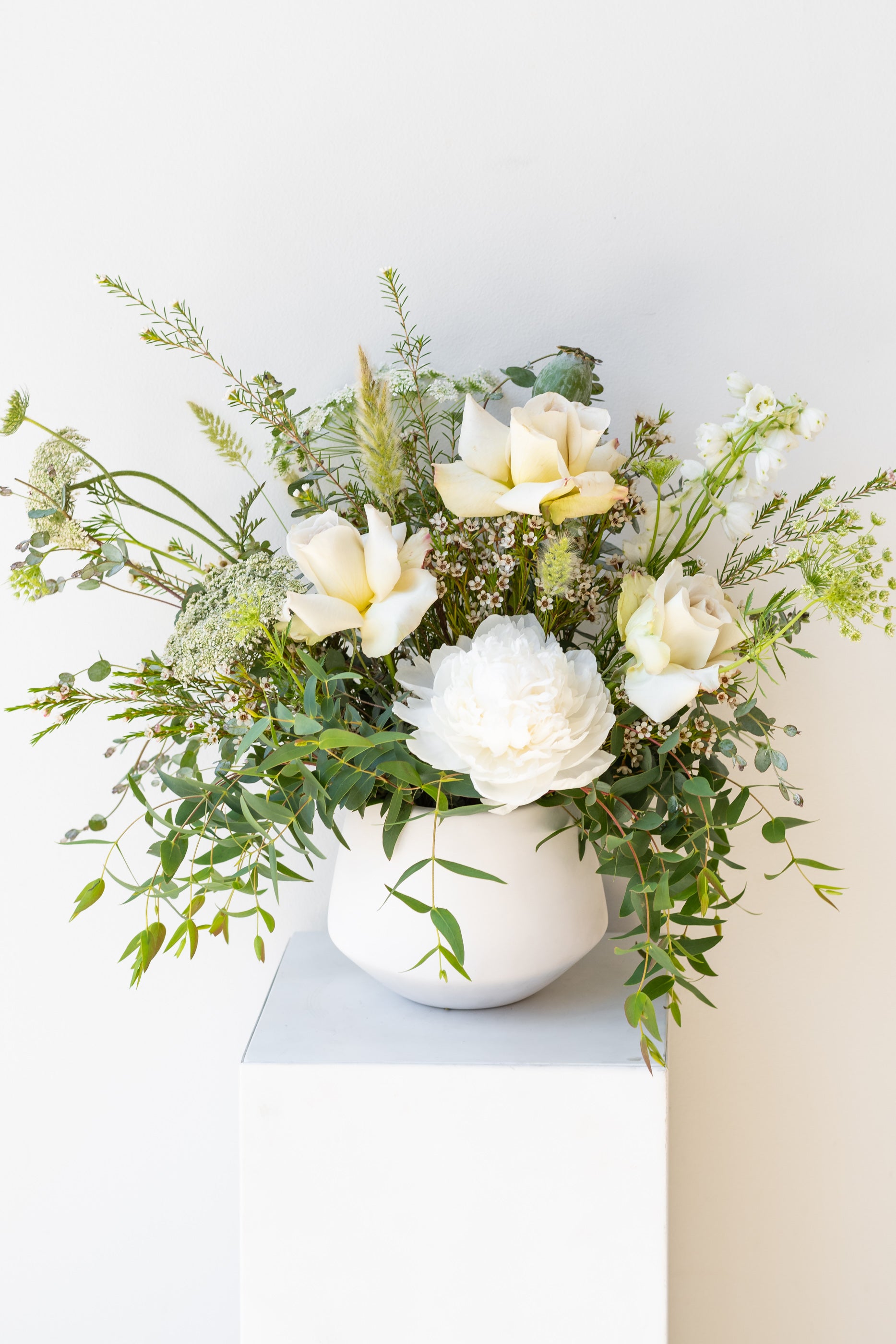 An example of Floral Arrangement Bleached by Sprout Home in Chicago. The arrangement uses primarily white flowers with green foliage. #size_$90