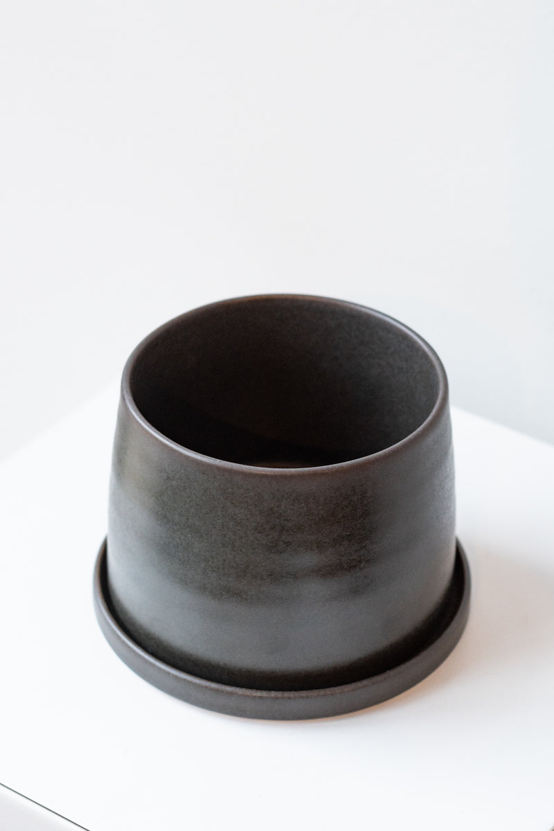 Kinto porcelain pot small black on white surface in white room