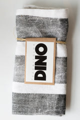 Grey and white striped placemat by Technicolor Dino resting on a white surface