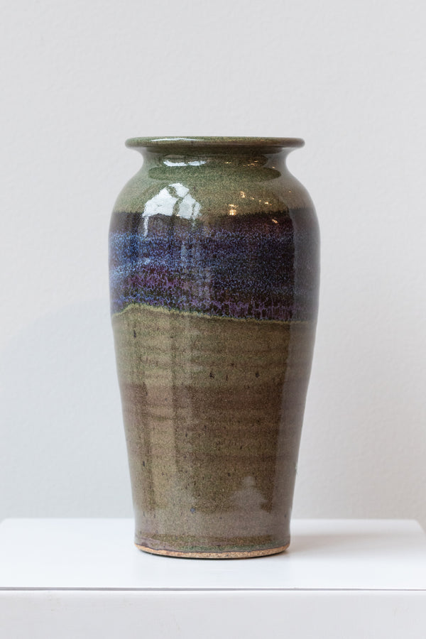 Bruning Pottery moss and lilac glazed tall ceramic vase in front of white background