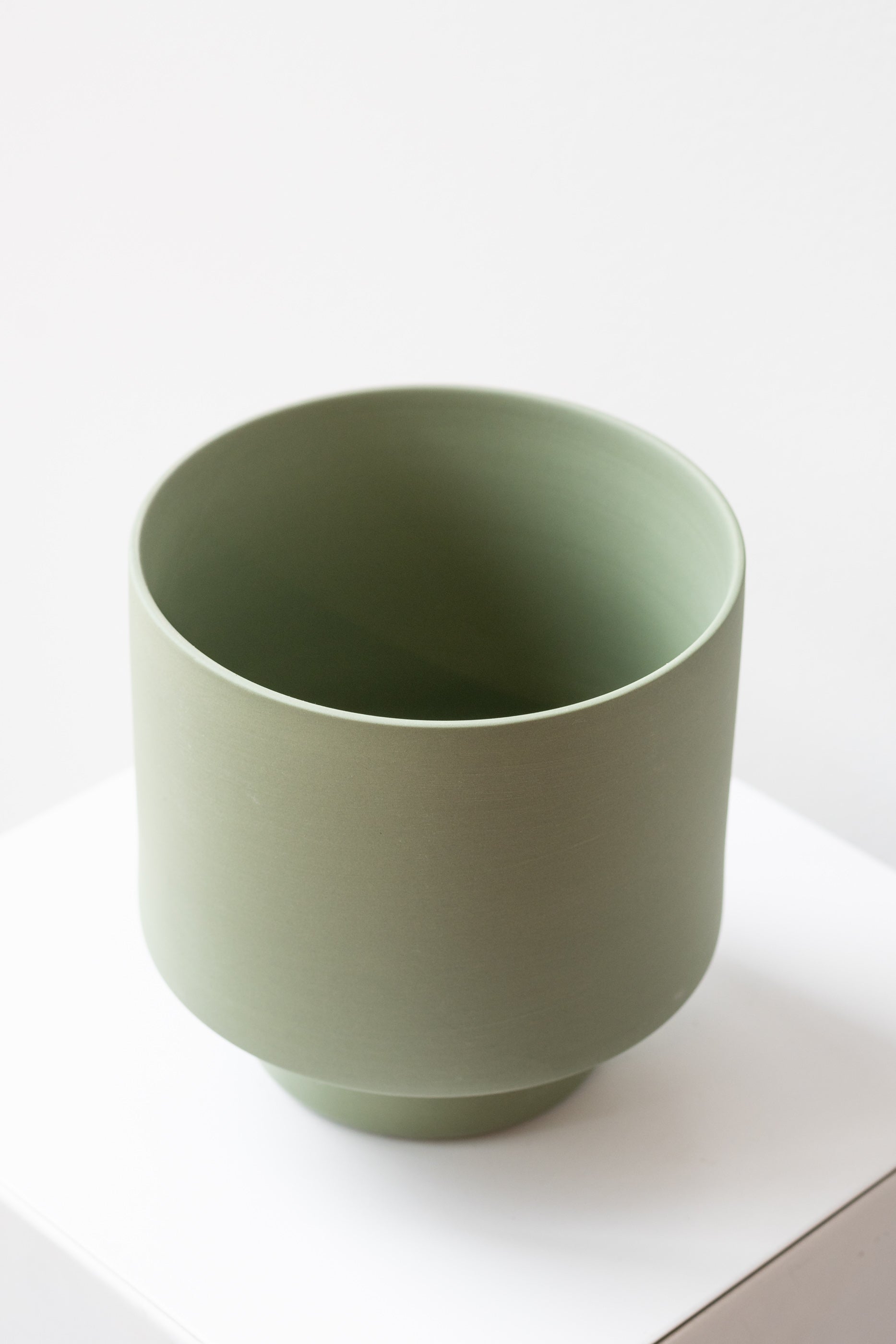 Angus & Celeste Collector's Gro pot olive large on white surface in front of white background