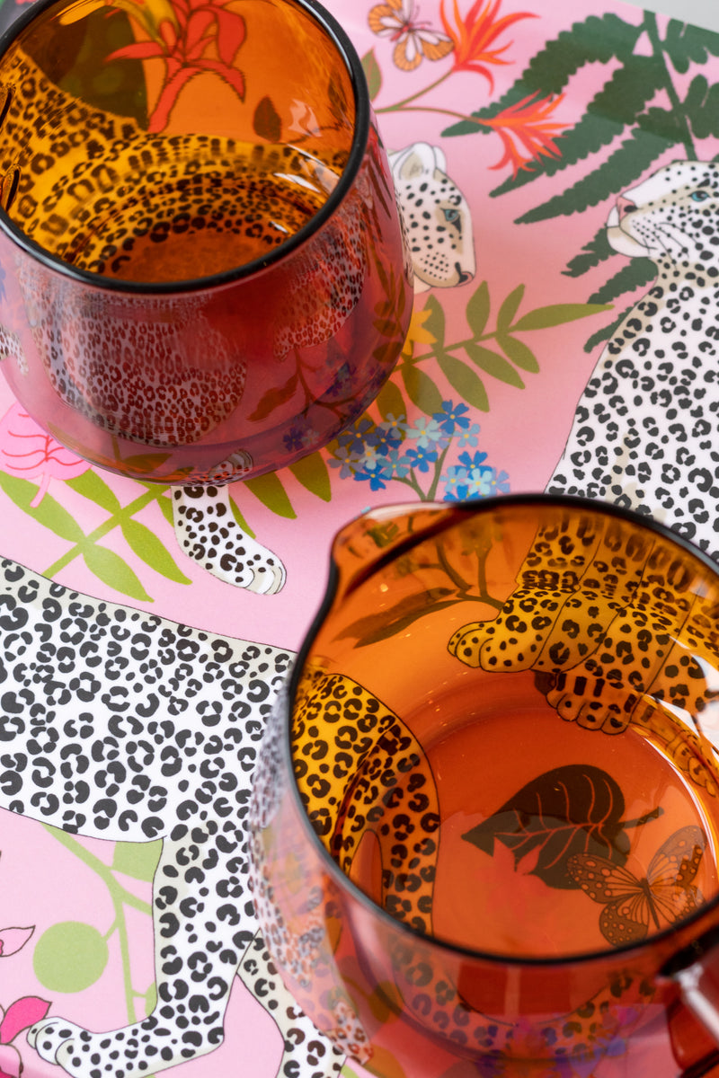 Close up of pink leopard birch wood tray with two amber glasses