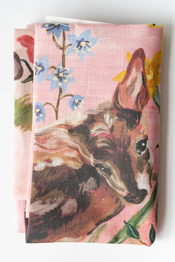 Folded Bambi illustrated tea towel on a white surface