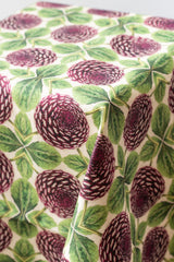 Close up of purple dahlia printed linen tablecloth draped over table