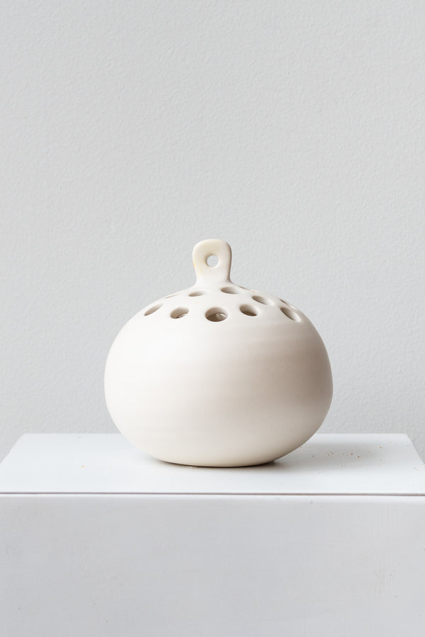 White Ceramic Hanging Flower Frog Vase on a white surface in a white room