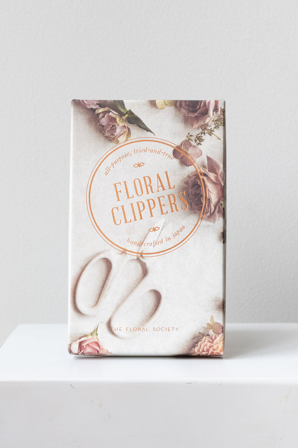 The Floral Society Floral Clippers box on a white surface in a white room