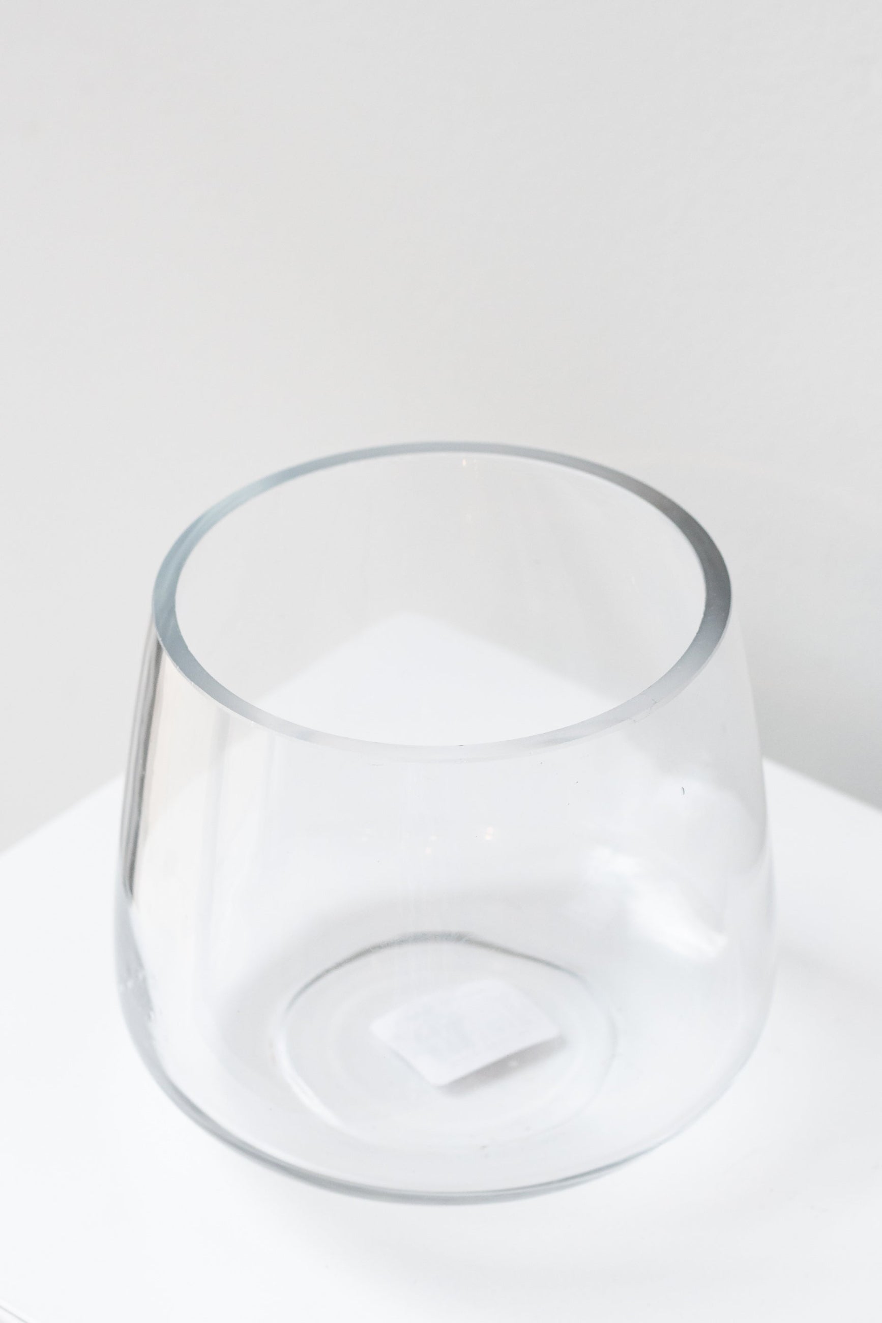 round bottom glass vase shown on a white surface, empty, and looking from above top corner ©Sprout Home