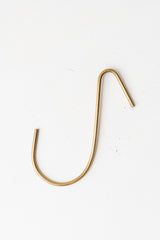 Medium brass hook by Fog Linen in front of white background