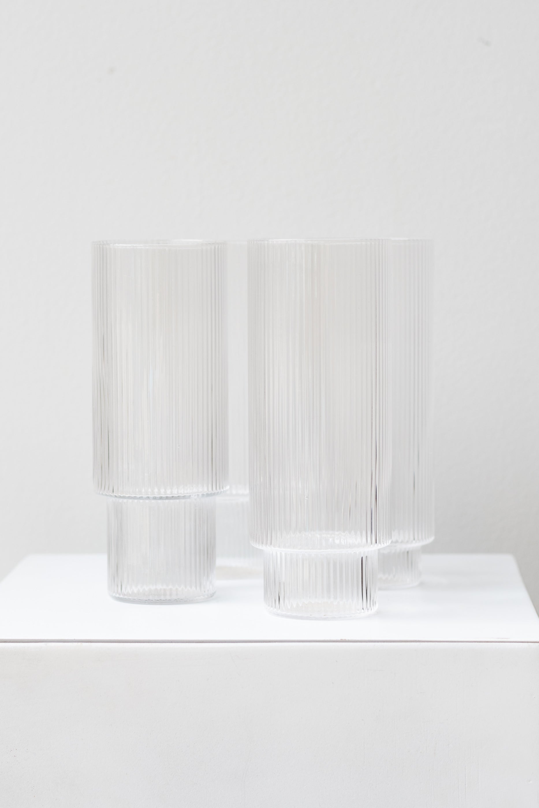 Ferm Living Ripple Long Drink Glasses Set of 4 glass clear on a white surface in a white room