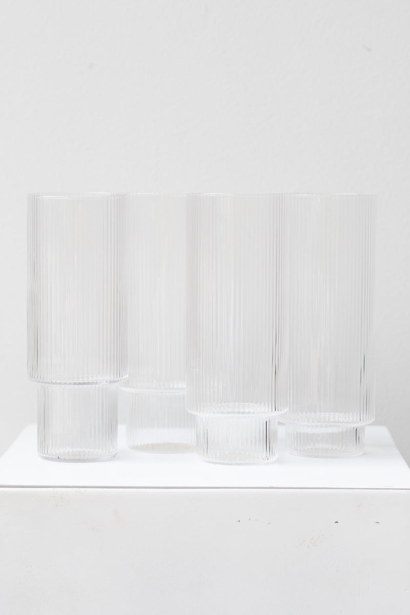 Ferm Living Ripple Long Drink Glasses Set of 4 glass clear on a white surface in a white room