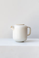 Cream-colored ceramic Sekki milk jar by Ferm Living in front of white background