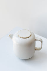 Cream-colored ceramic Sekki milk jar by Ferm Living in front of white background