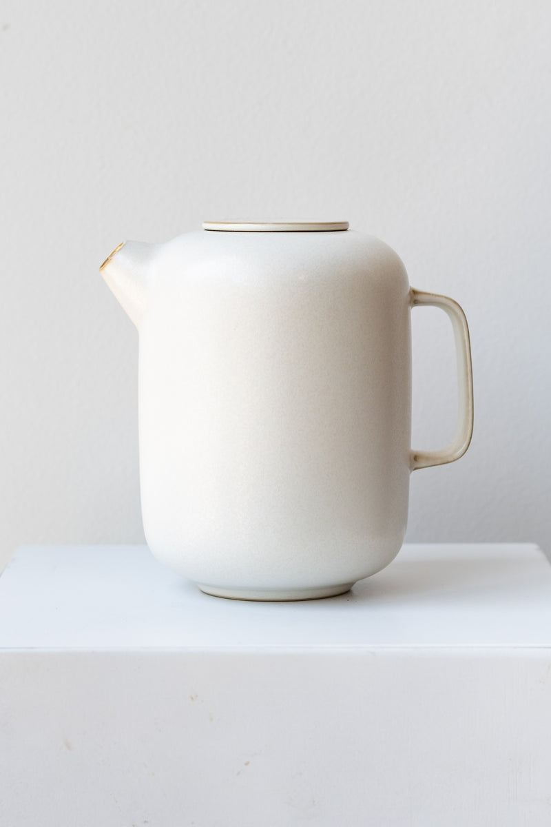 Cream-colored Sekki ceramic coffee pot by Ferm Living in front of white background