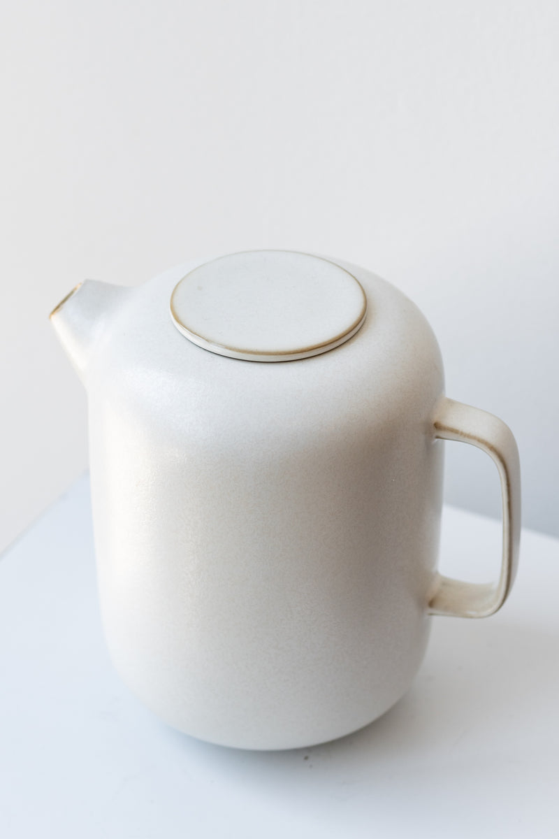 Cream-colored Sekki ceramic coffee pot by Ferm Living in front of white background