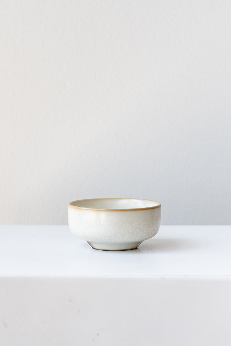 Cream-colored ceramic Sekki salt jar by Ferm Living in front of white background