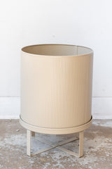 Large cashmere Bau Pot by Ferm Living on a concrete floor in front of white background