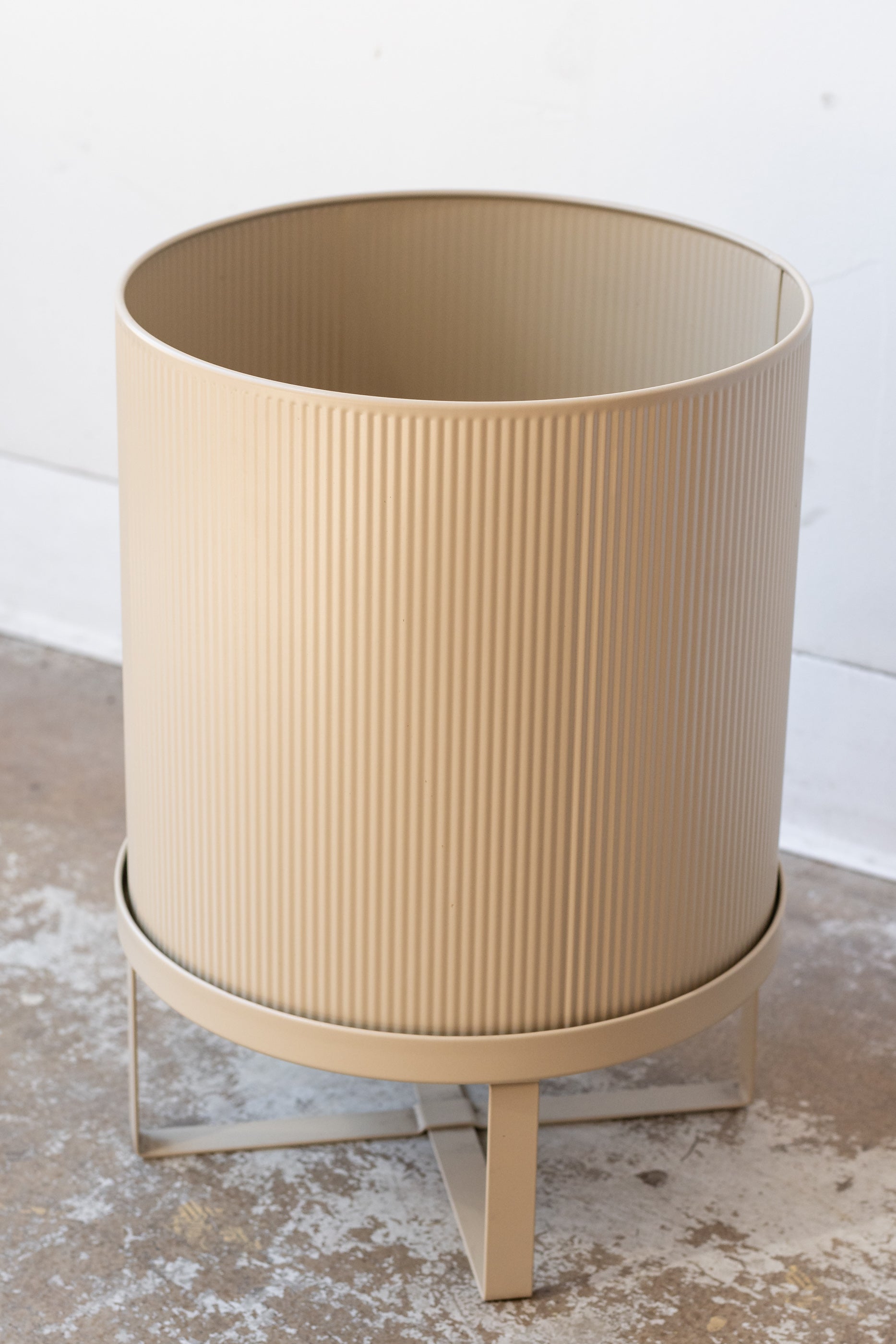 Large cashmere Bau Pot by Ferm Living on a concrete floor in front of white background