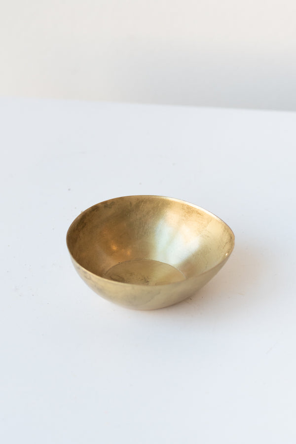 Alma Brass Tealight Holder on a white surface in a white room