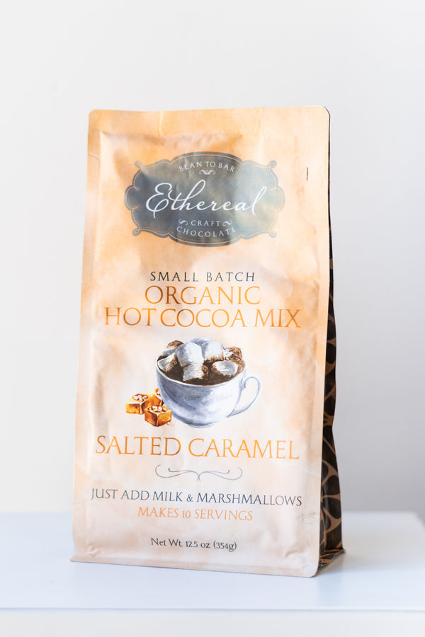 Ethereal Chocolate Salted Caramel hot cocoa mix bag on a white surface in a white room