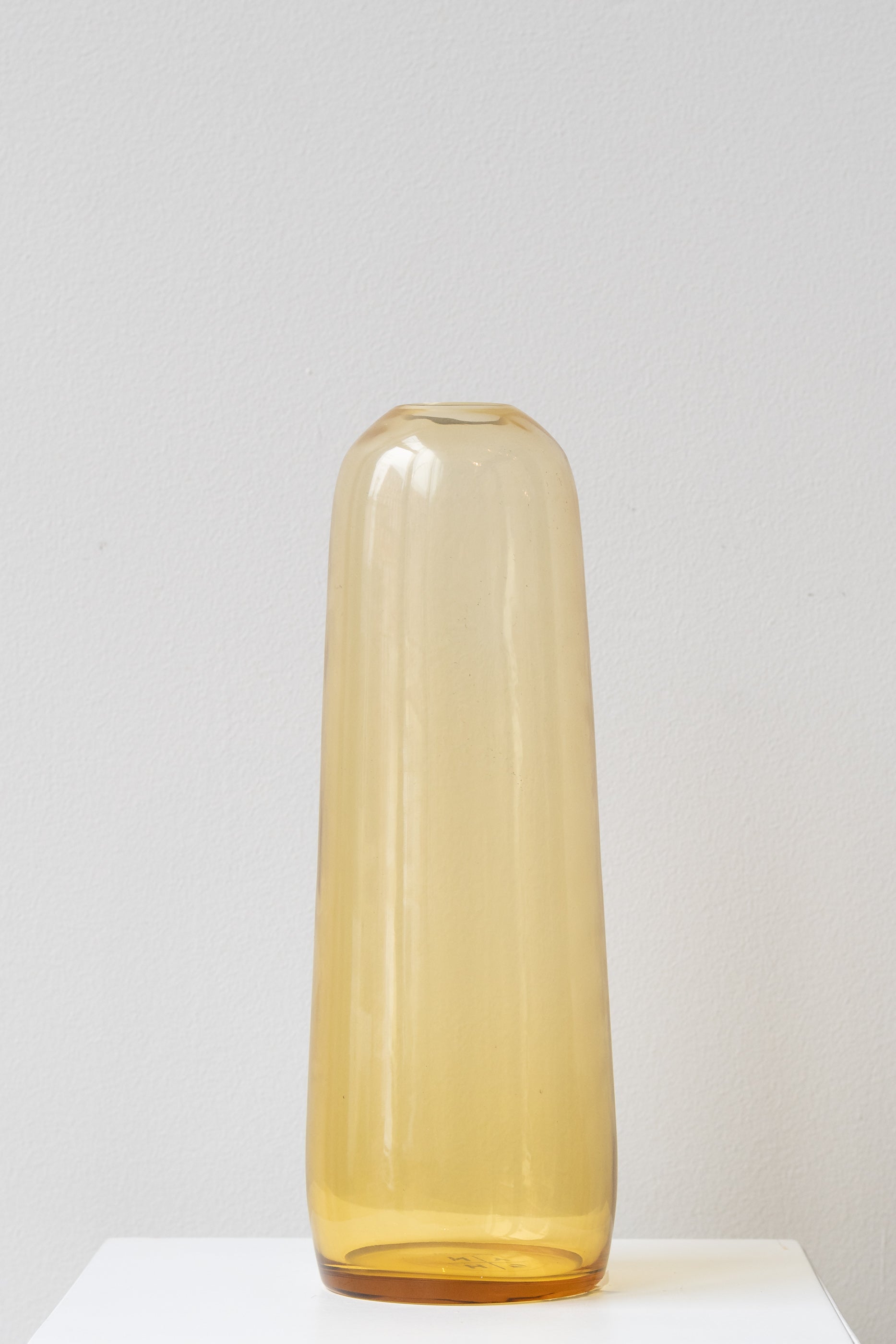 Hawkins New York small amber Aurora Pill Vase on white surface in front of white background