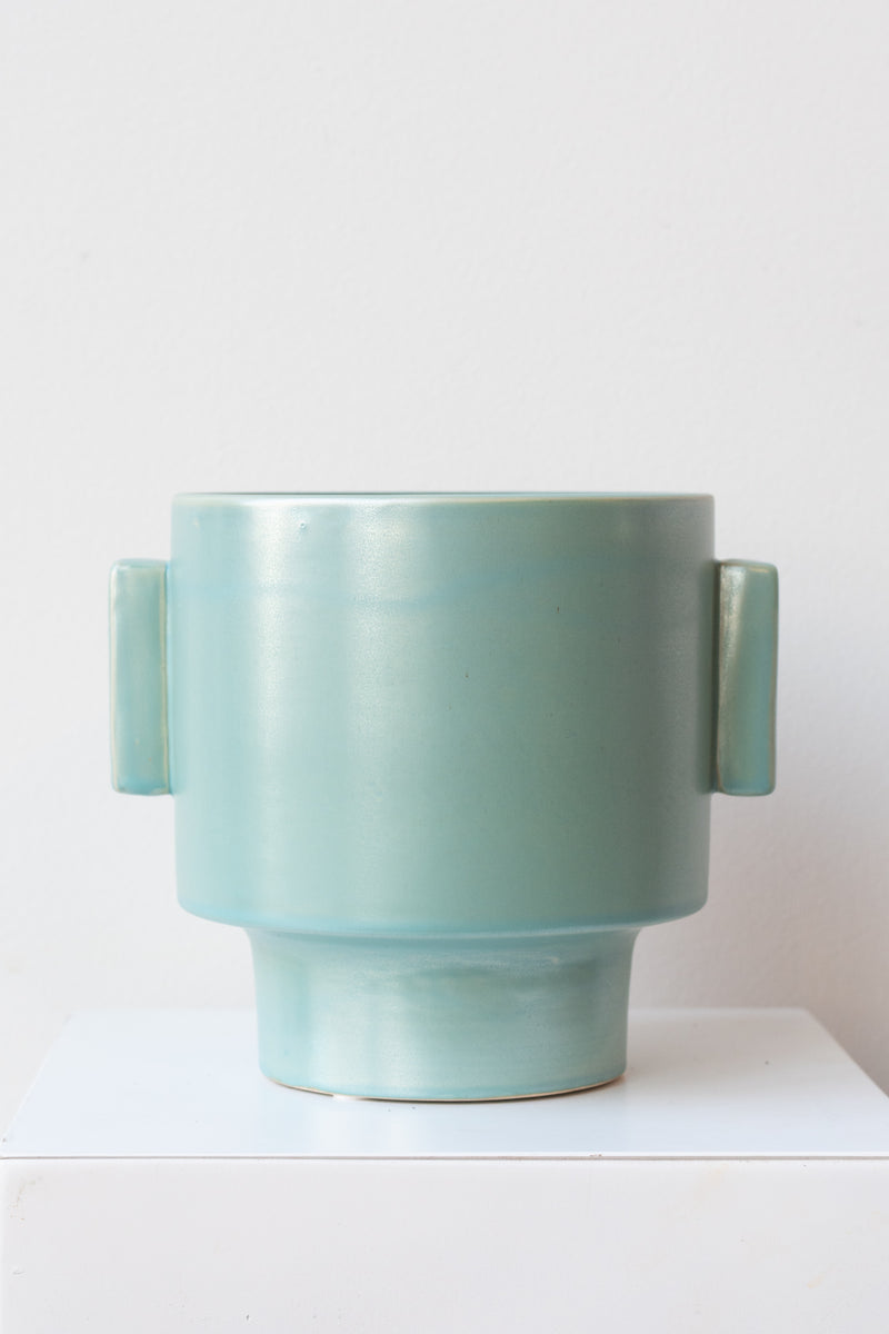 A full-body view of the matte aqua ~7" pot against a white background