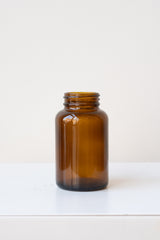 A full-body frontal view of the 120cc amber glass bottle against a white backdrop