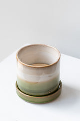 Small Green Layers Minute Pot sits on a white surface in a white room