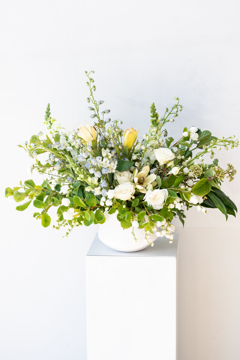An example of Floral Arrangement Bleached by Sprout Home in Chicago. The arrangement uses primarily white flowers with green foliage.