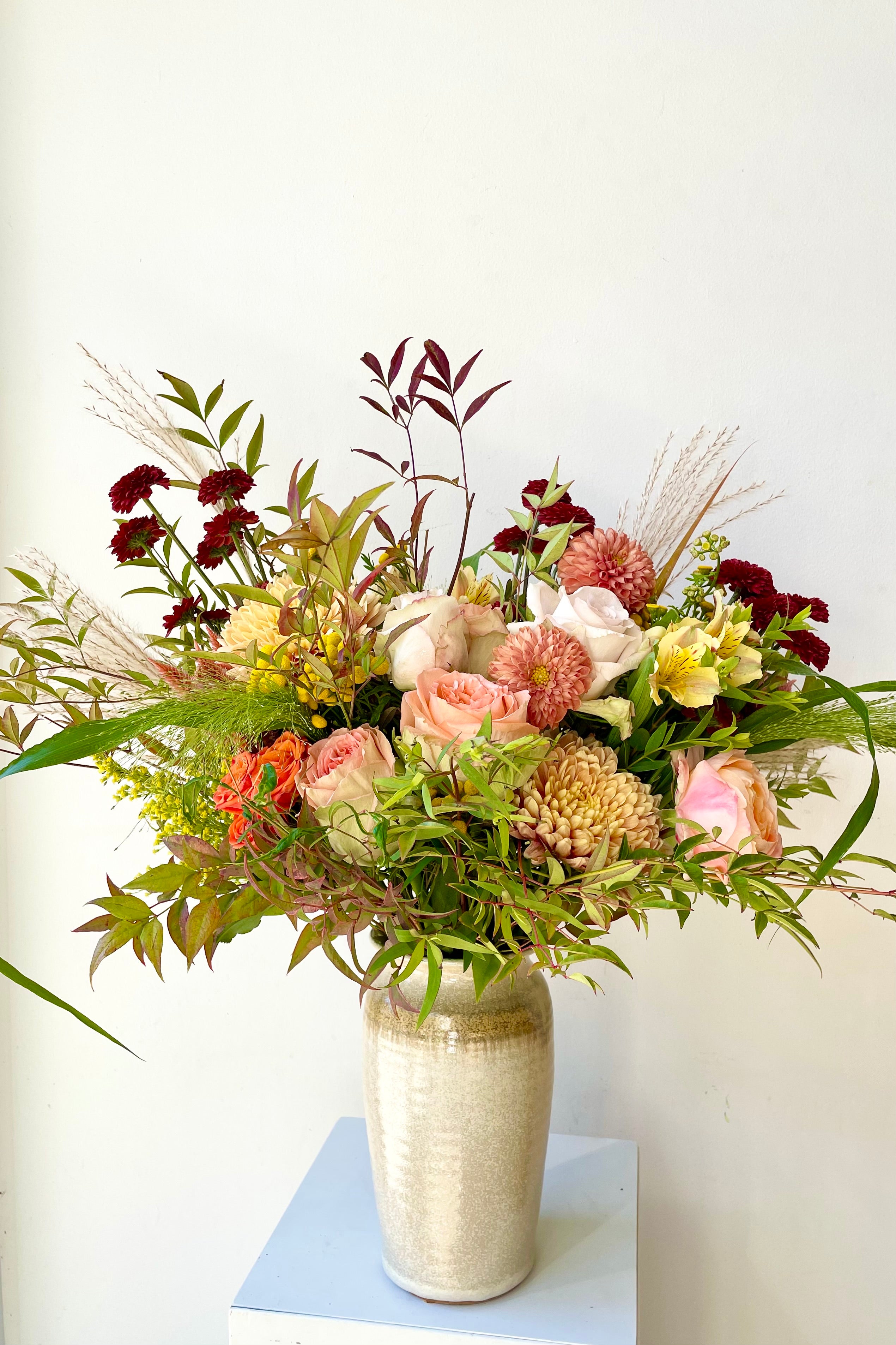 An example of Floral Arrangement Dusk from Sprout Home sits in a vase against a white backdrop #size_$160