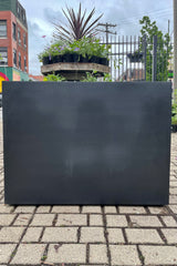 Jort Fiberstone Planter black large against the sprout home garden