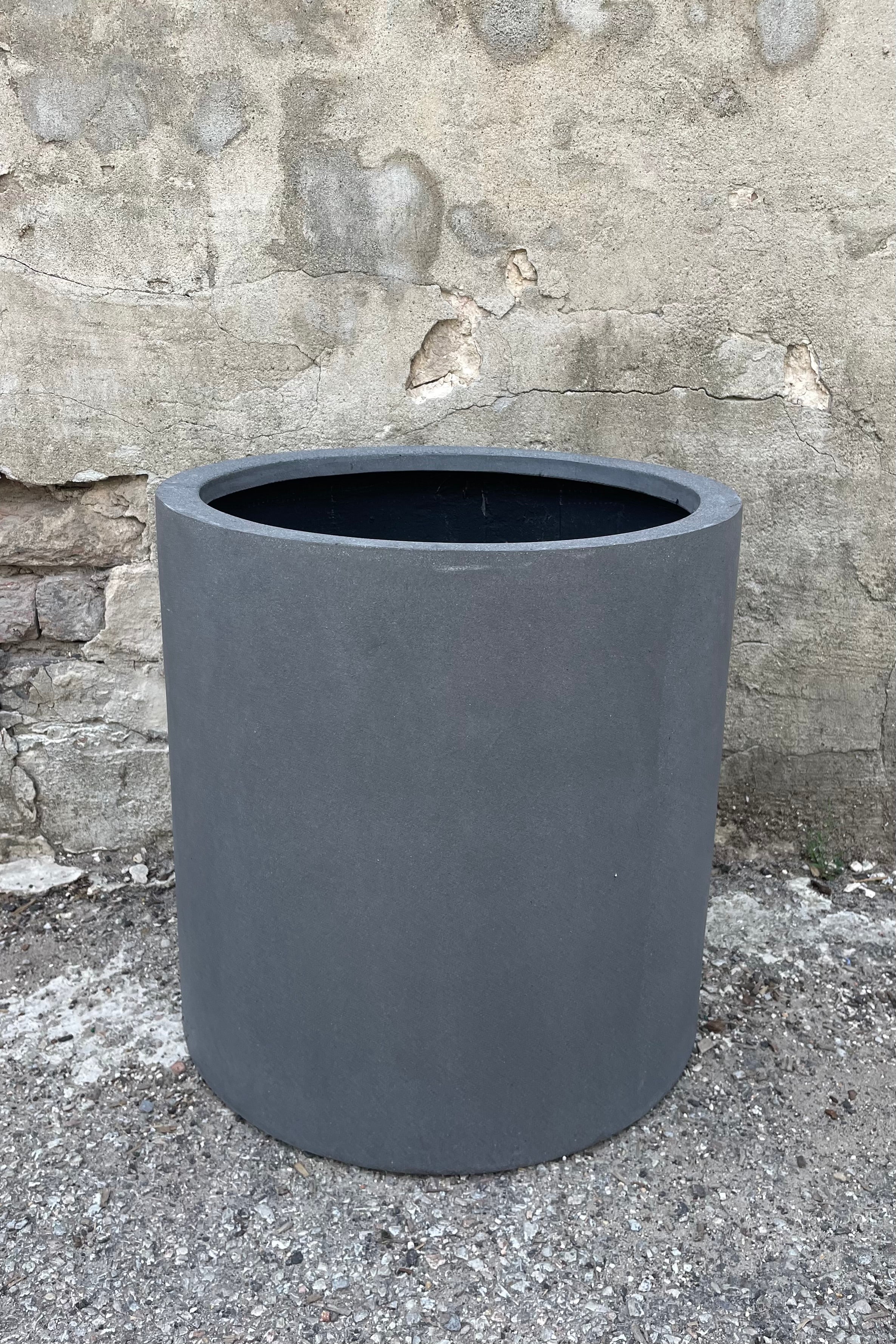 Max Pot Matte Grey Medium straight on against a grey wall 