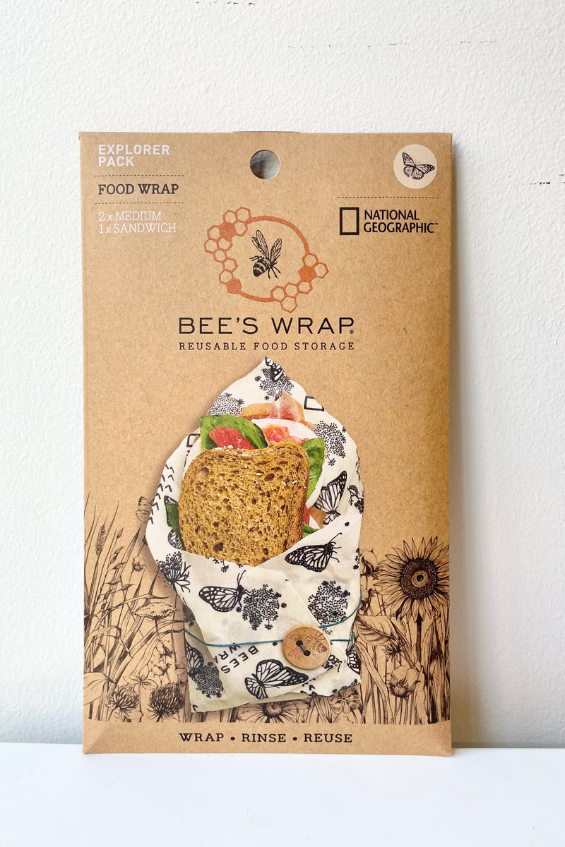 The packaging of the Bees Wrap Explorer pack showing a sandwich wrapped with the wrap.
