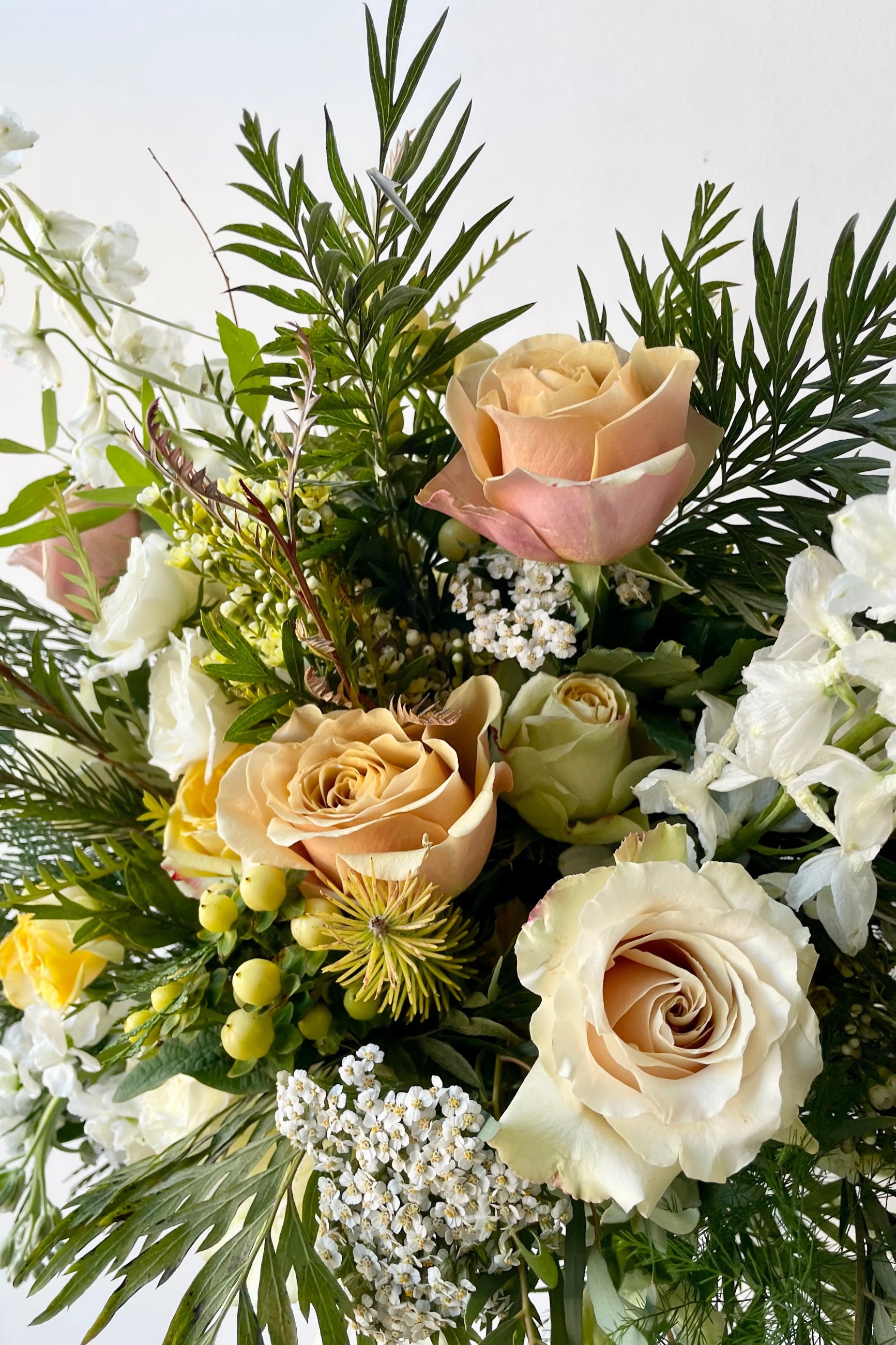 A detail view of fresh Floral Arrangement Champagne Toast with golden salmon roses from Sprout Home Floral in Chicago ©Sprout Home  #size_$200 