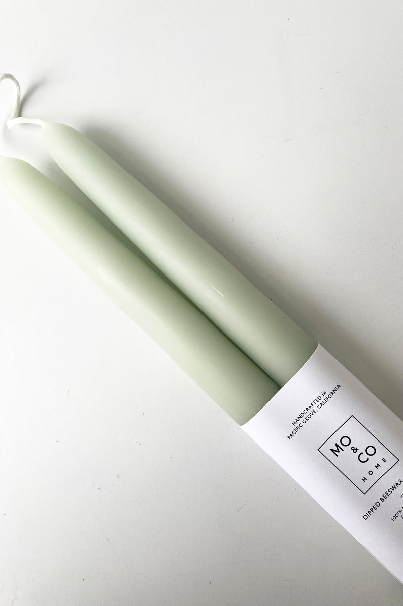 An overhead detailed view of the Eucalyptus 14" Taper Candles, pair against a white backdrop