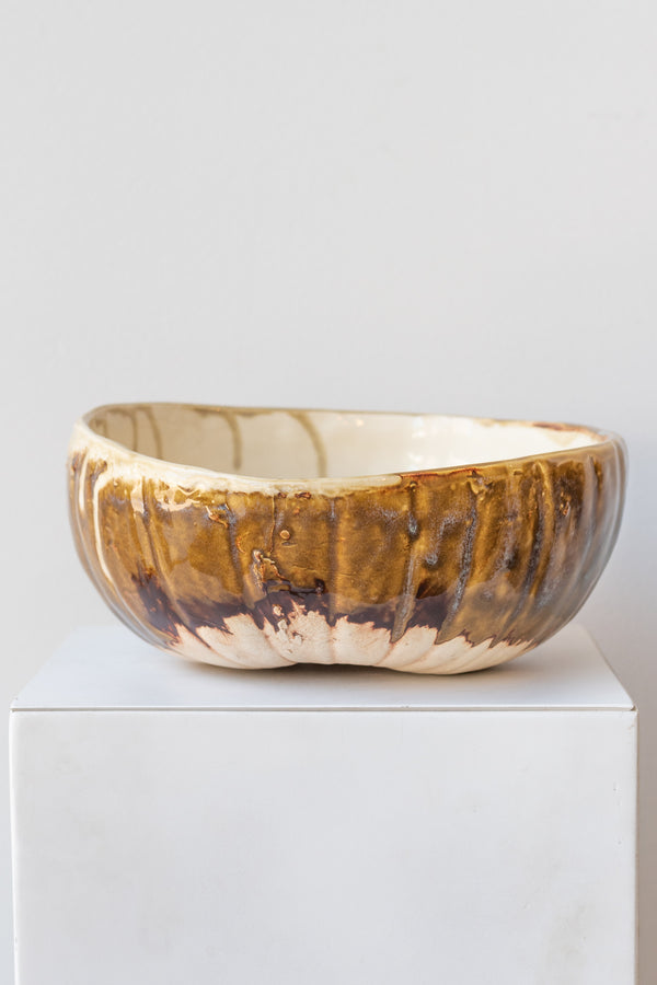 Beiko Ceramics Bowl homegrown pumpkin cream rust glaze on a white pedestal in a white room