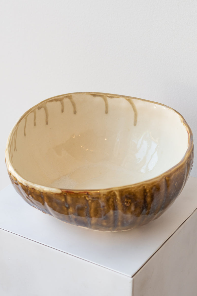 Beiko Ceramics Bowl homegrown pumpkin cream rust glaze on a white pedestal in a white room