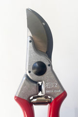 A detailed view of locking mechanism and blade on the Felco #2 Pruner against white backdrop