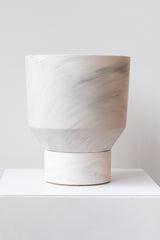 The Northern Habitat Funnel Planter grey marble on white surface in front of white background