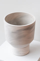 The Northern Habitat Funnel Planter grey marble on white surface in front of white background