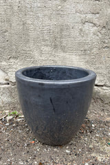 Egg Ceramic Planter Graphite Small against a grey wall