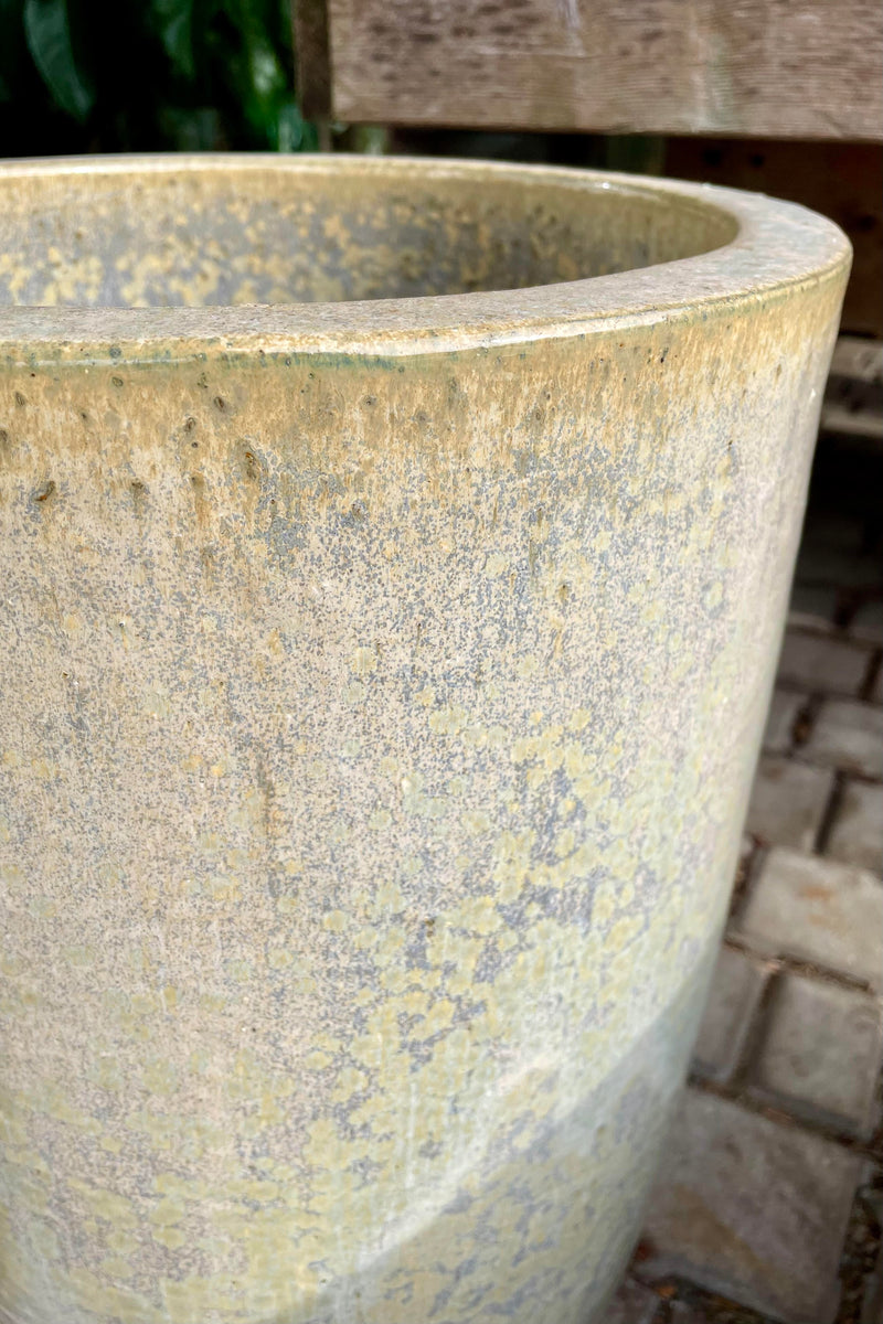 Detail photo of glaze of ceramic Crucible planter with brick background