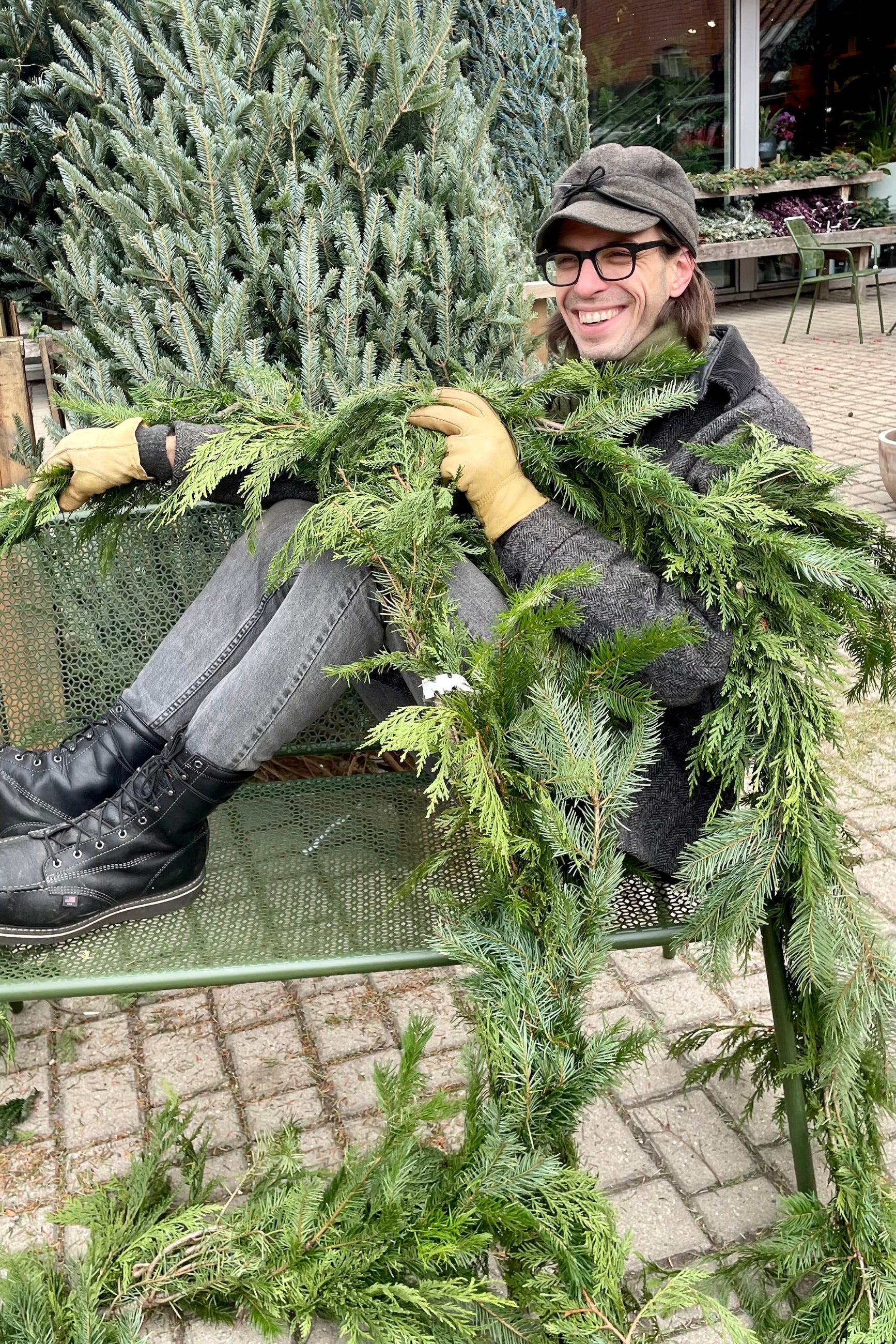 Stephen holding a roll of Cedar and Douglas fir mixed garland at Sprout Home  ©Sprout Home