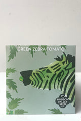 A front view of the Green Zebra Tomato Seeds Art Pack against white backdrop