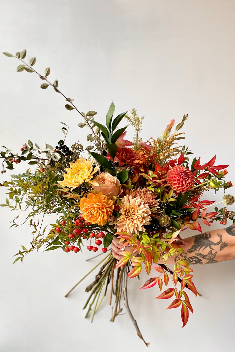 'Harvest Moon' arrangement by Sprout Home showing the variation of fall color in leaves and flowers. 