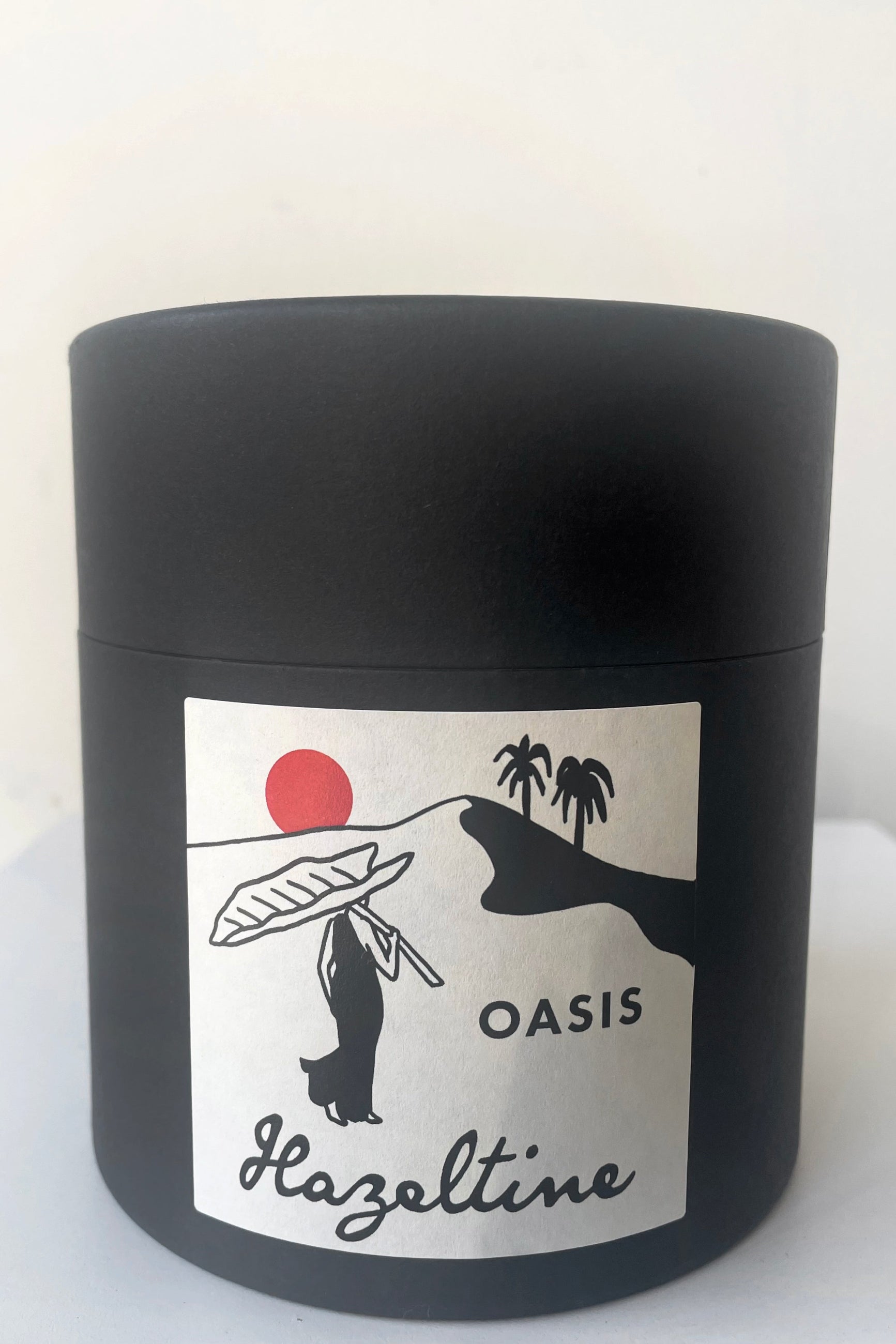 A view of the packaging of Hazeltine Candle oasis against white backdrop ©Sprout Home