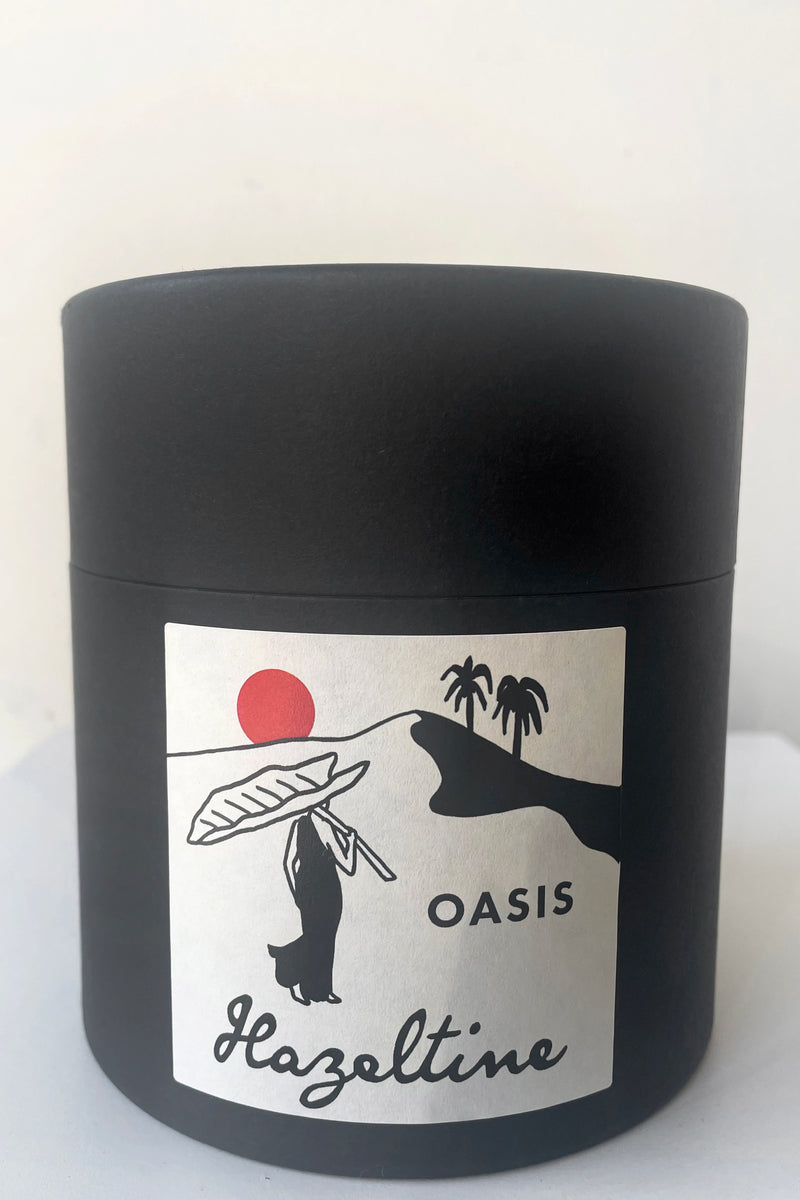A view of the packaging of Hazeltine Candle oasis against white backdrop