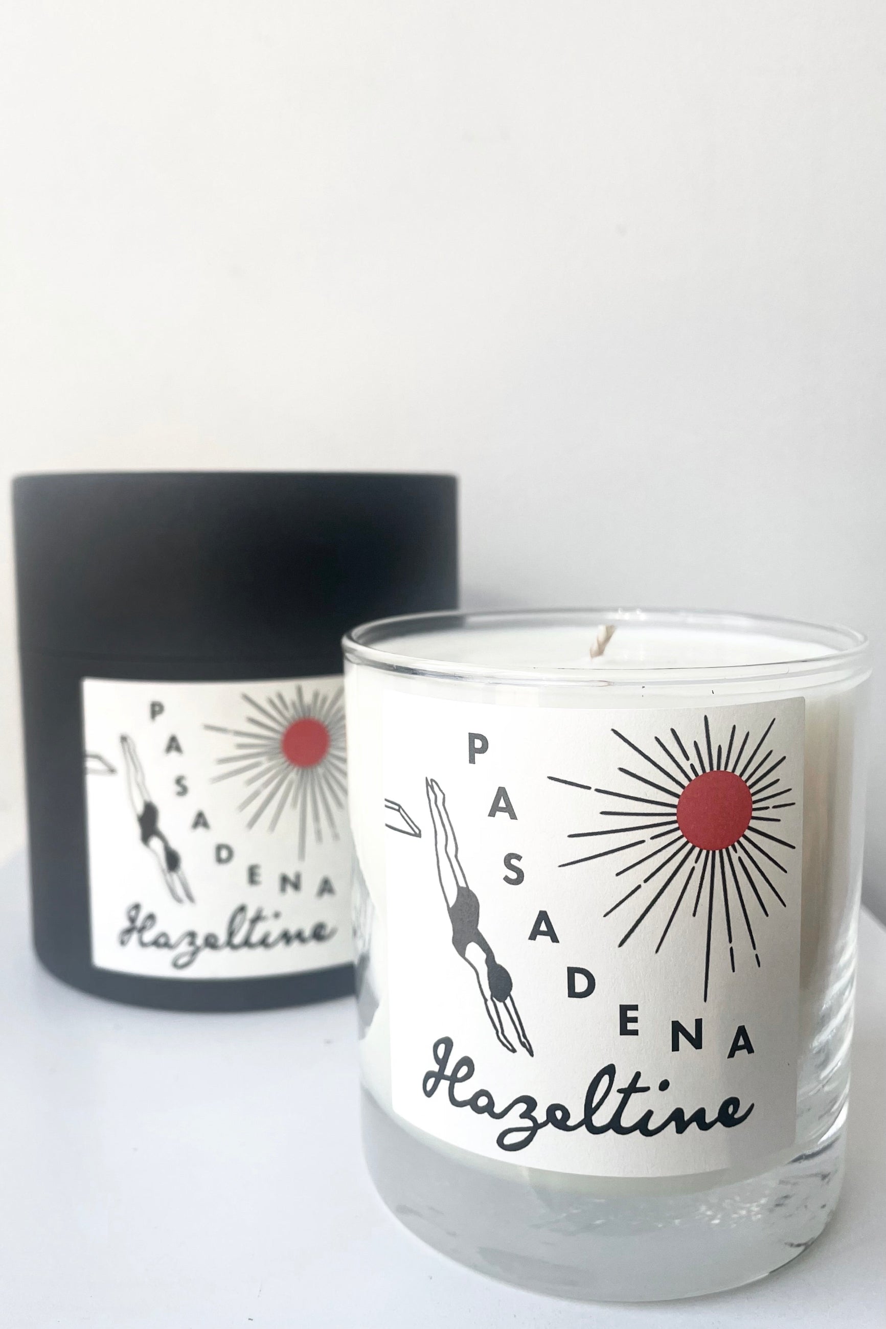 A view of the packaging and candle of Hazeltine Candle pasadena against white backdrop ©Sprout Home