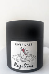 A full view of packaging of Hazeltine Candle river daze against white backdrop