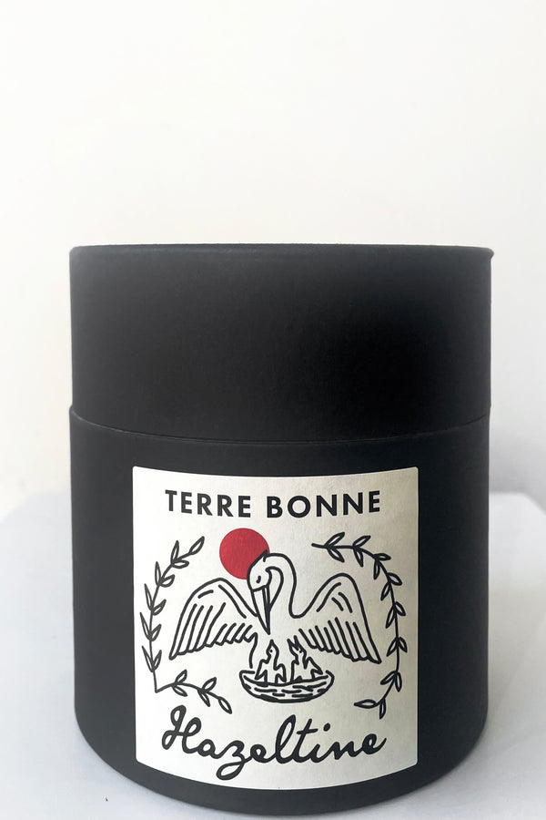 A full view of packaging of Hazeltine Candle terre bonne against white backdrop