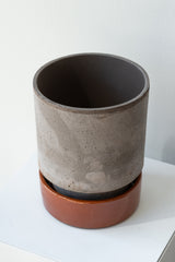 Grey and red 5.5 inch Hoff Pot by Bergs Potter on a white surface in a white room